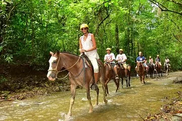 Riders on horseback through jungle trails near Manuel Antonio, Costa Rica