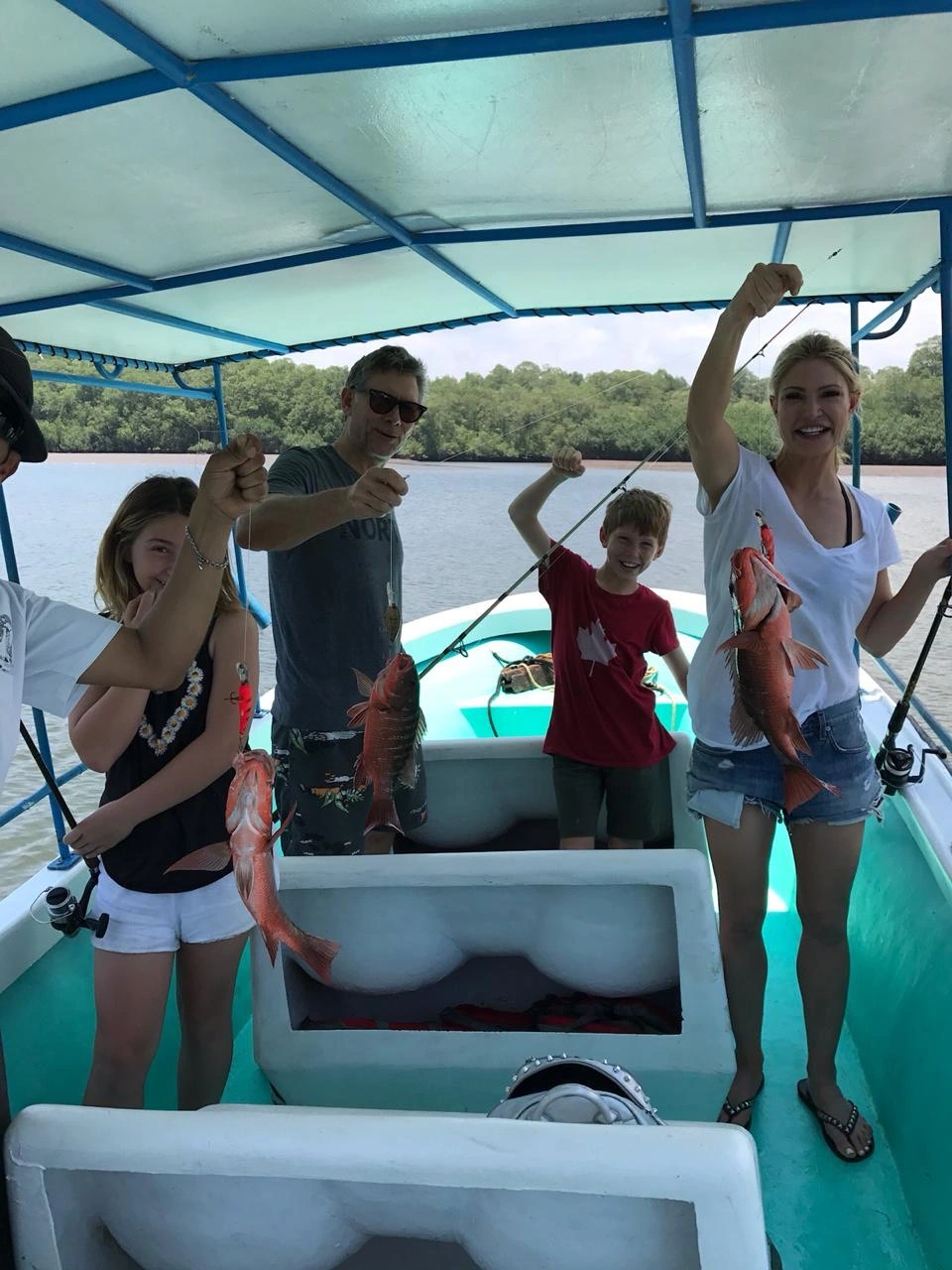 Family with their catch on an Isla Damas mangrove fishing charter near Manuel Antonio, Costa Rica