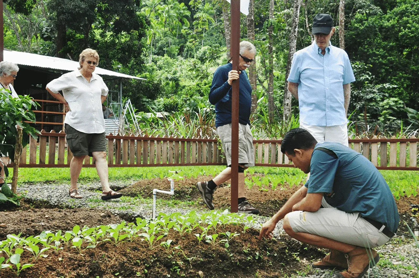 Cooking class participants preparing traditional dishes at the Londres farm